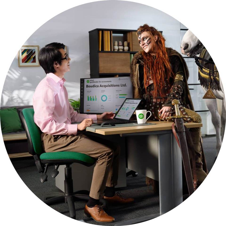 A person sitting at a desk with a laptop computer.