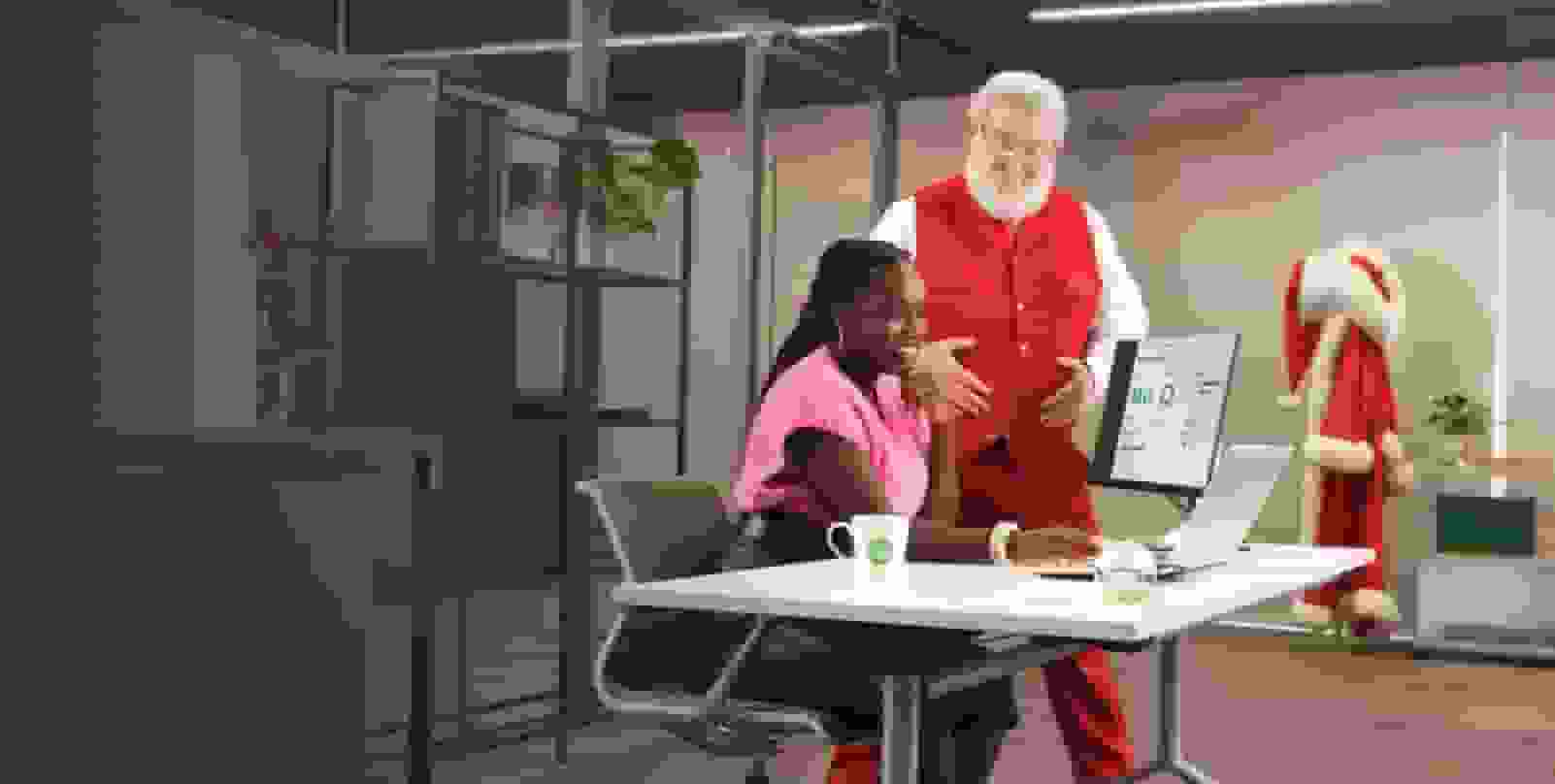 A person sitting at a desk with santa.