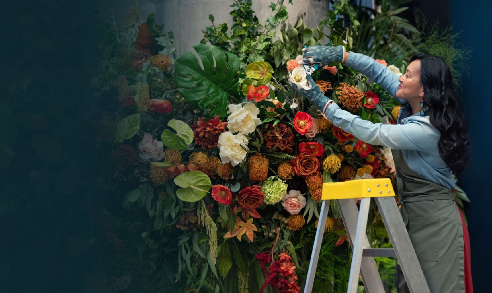 A person is painting a flower vase with flowers.