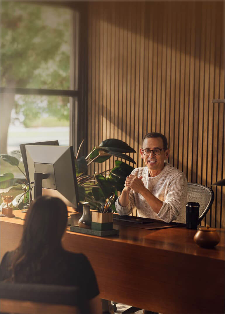 A person sitting at a desk in front of a computer.