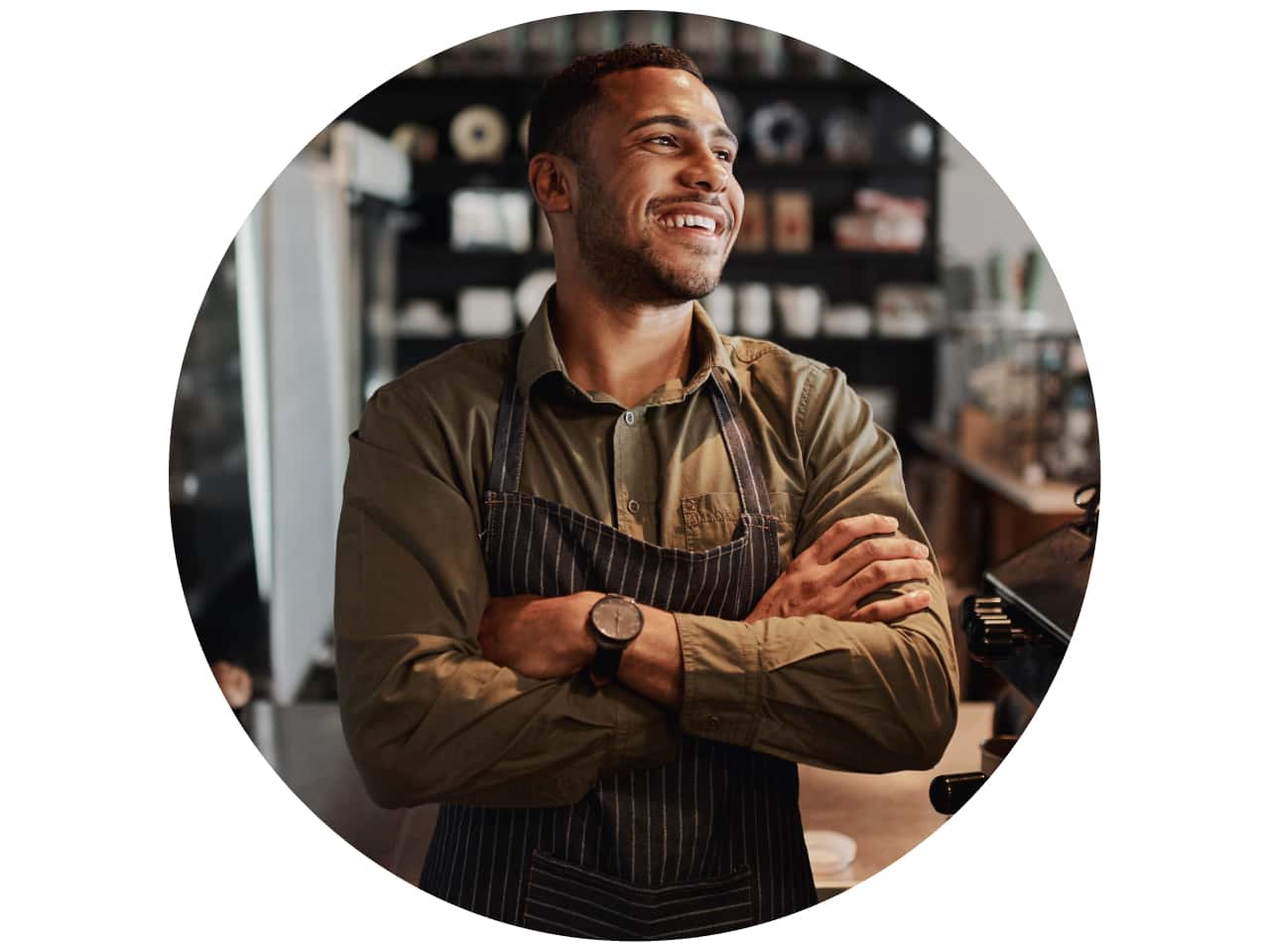 A person smiling while holding a cup of coffee.