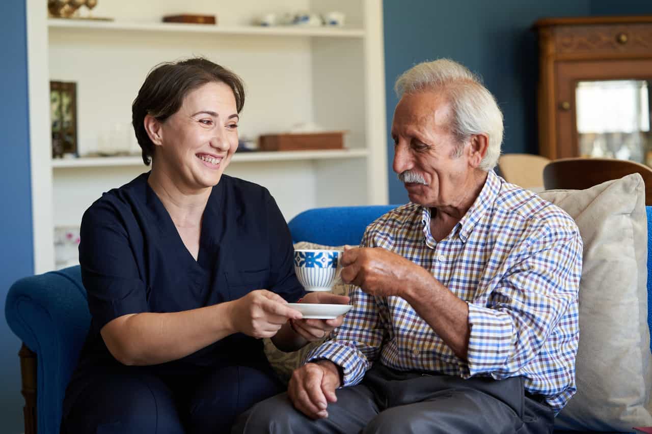 A person and person sitting on a couch together.