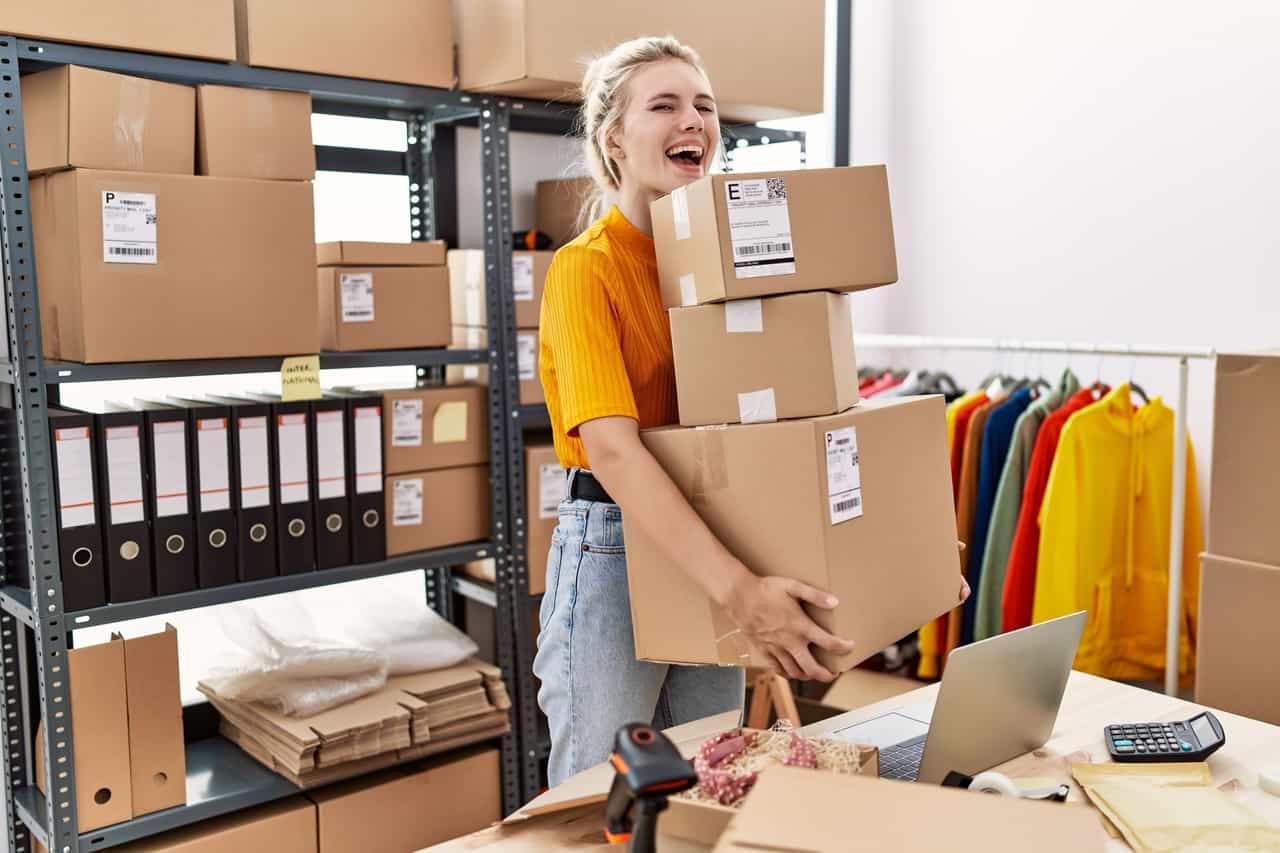 A person is standing in a room with boxes.