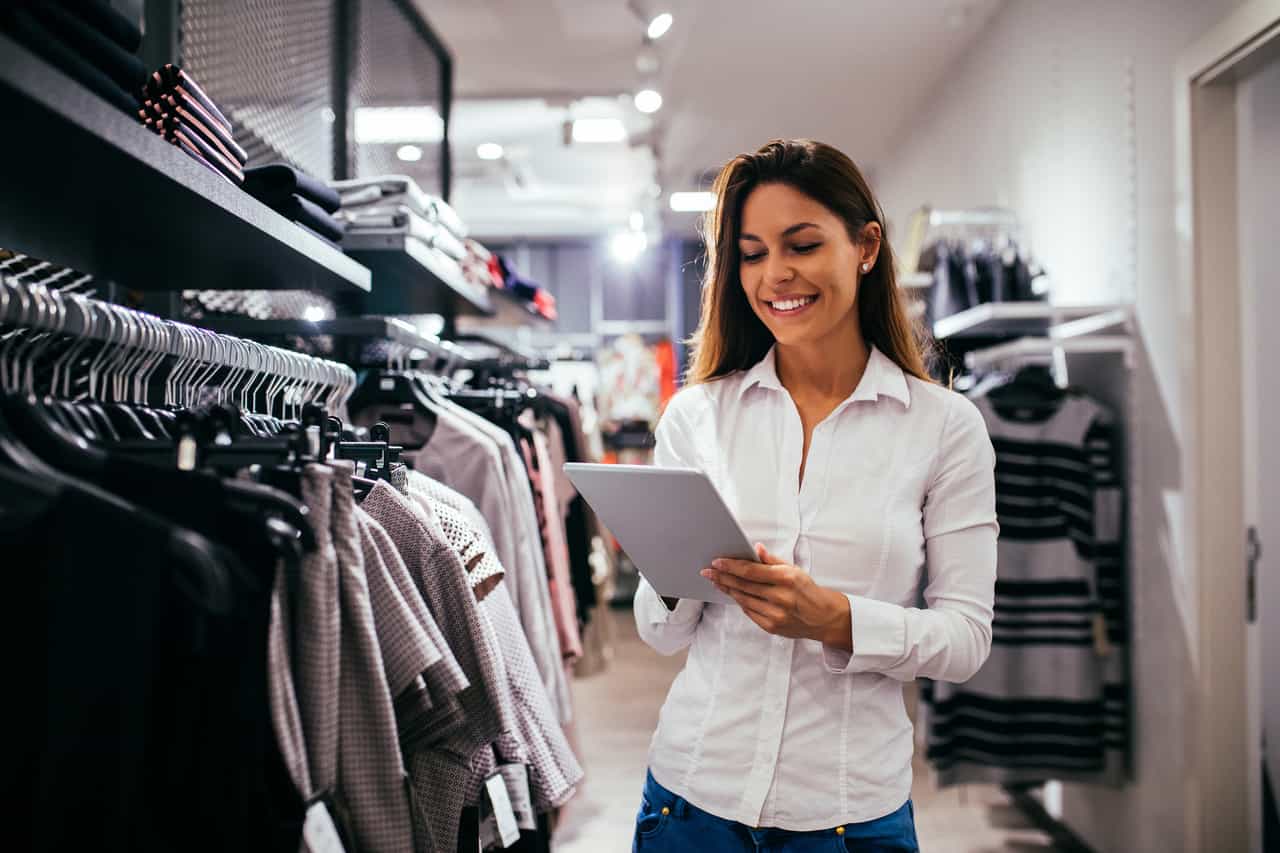 A person in a store looking at a piece of paper.