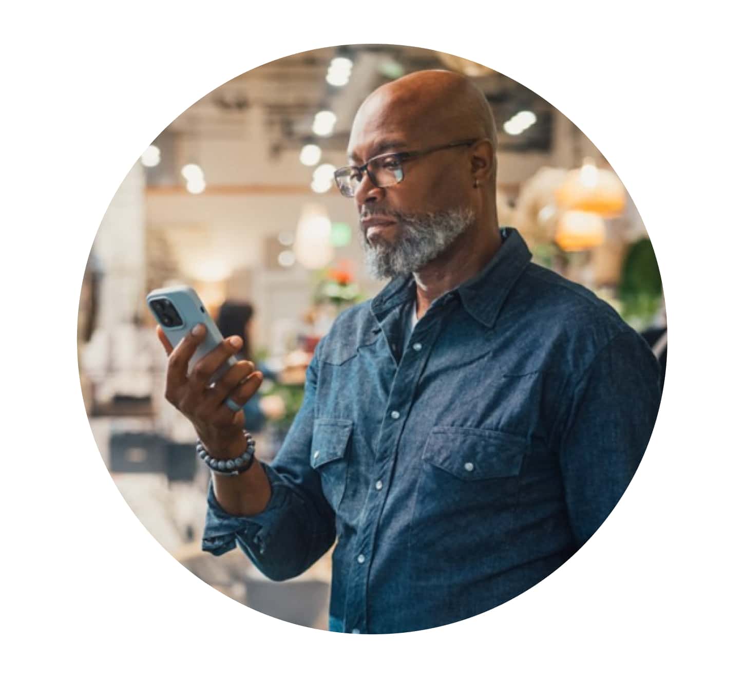 A person holding a glass of milk and a cell phone.