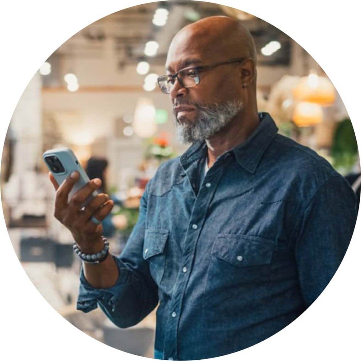 A person holding a glass of lemonade in his right hand.