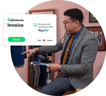 A person in a green shirt and a tie is checking his balance.