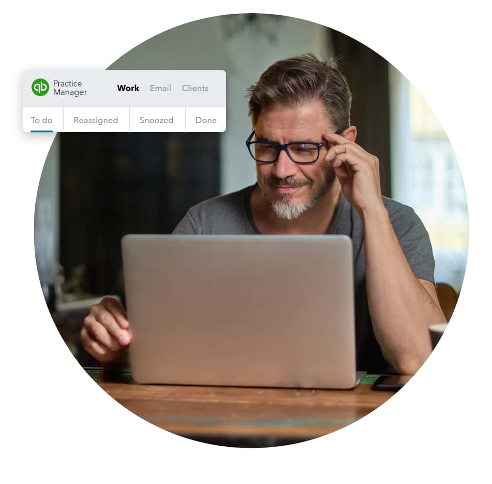 A person sitting at a table with a laptop computer.