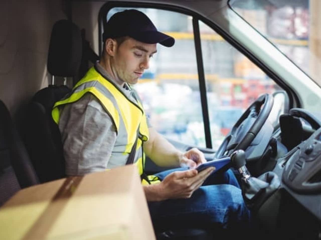Image of man in a van using a tablet