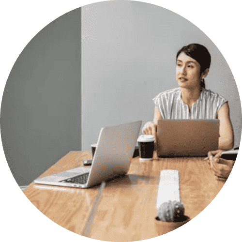 A black and white image of a person with a laptop.