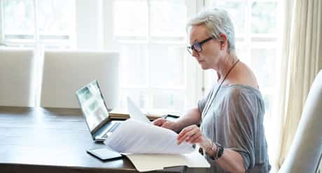 A person sitting at a desk with a laptop.