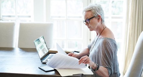 A person sitting at a desk with a laptop.