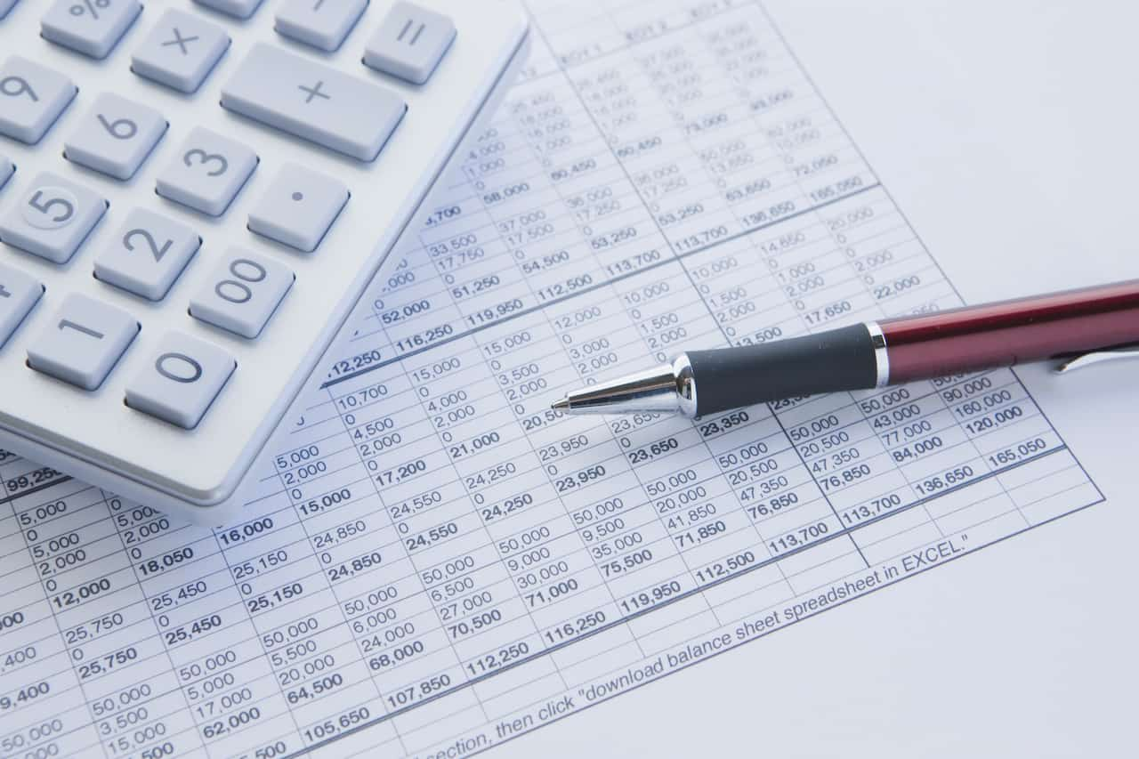 calculating unearned revenue with spreadsheet and pen