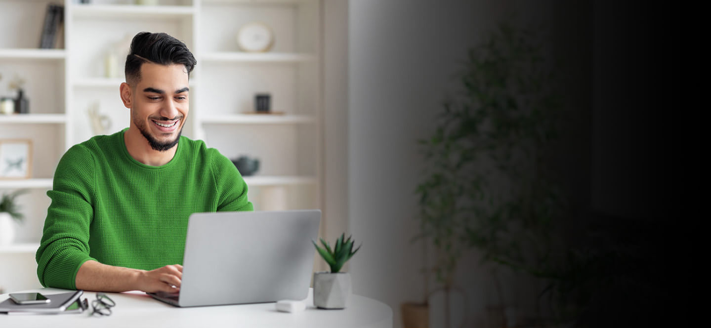 A person sitting at a desk with a laptop.