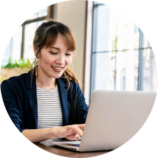 A person sitting at a table with a laptop.