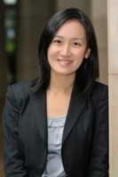 A person in a suit and tie smiles.