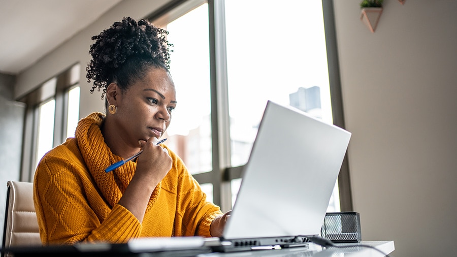 An image of a business owner researching federal withholding tax tables.