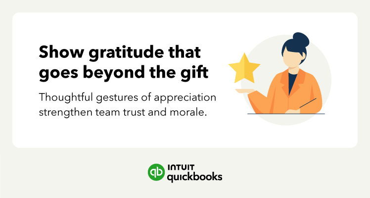 Manager smiling and handing a small gift to an employee in a bright office, showing appreciation and fostering a positive workplace culture.