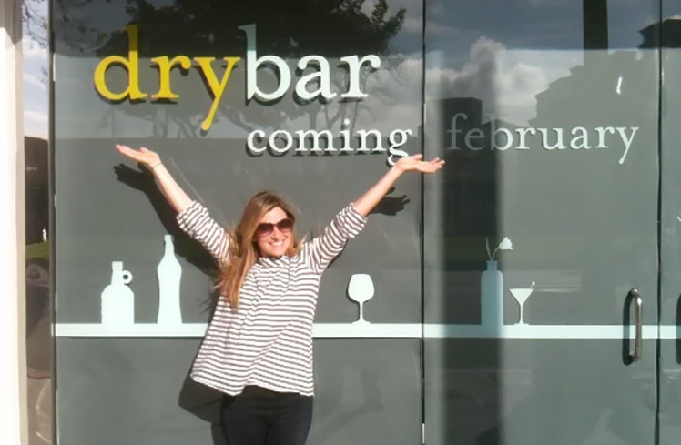 Alli Webb standing in front of a Drybar store front