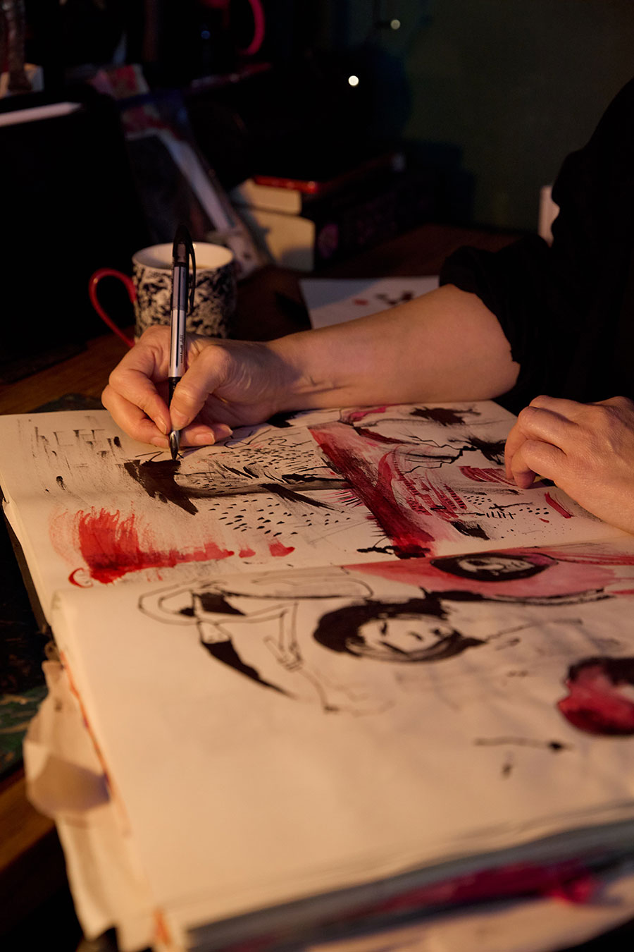 A person is painting a picture with pen and ink.