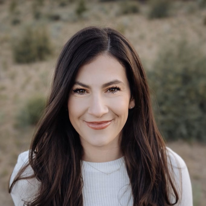 A person smiling and posing for a picture.