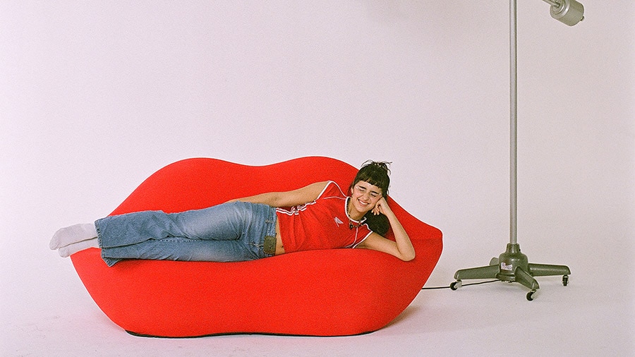 A person sitting on a red couch