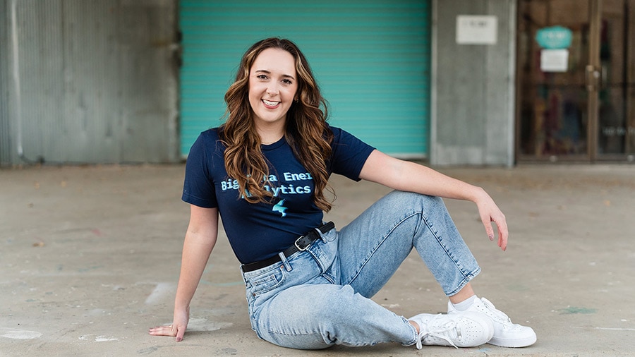 A person sitting on the ground with a tshirt on.