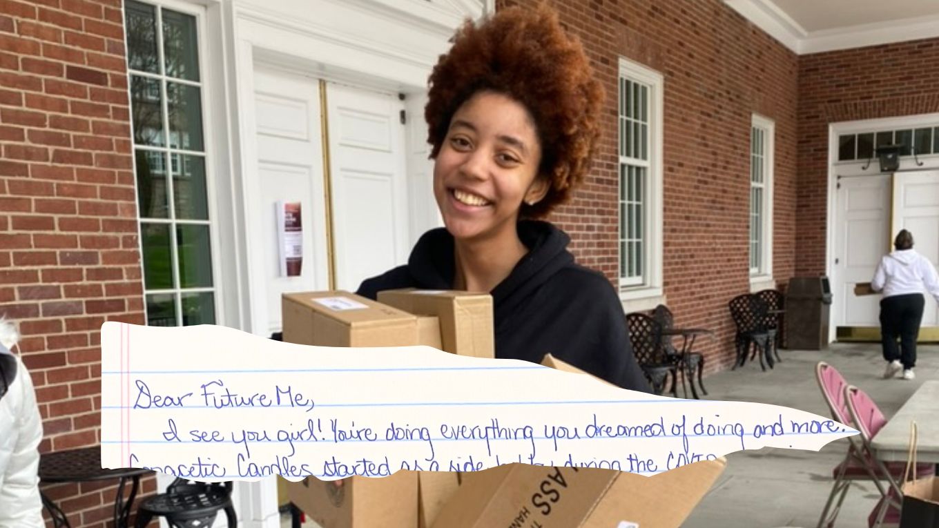 A person is smiling while holding a piece of paper.