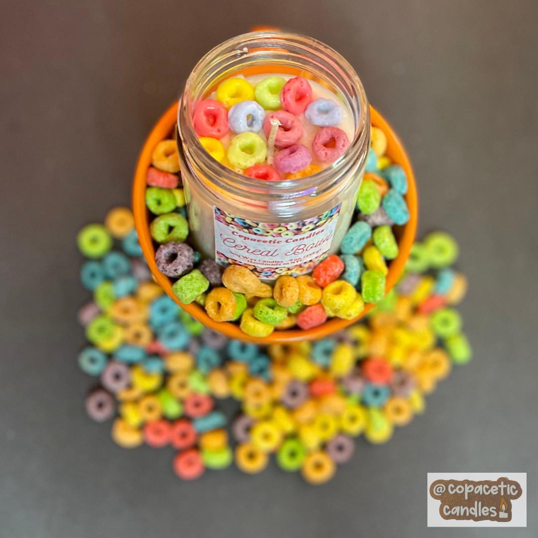 A multi colored candy jar with candy decorations.