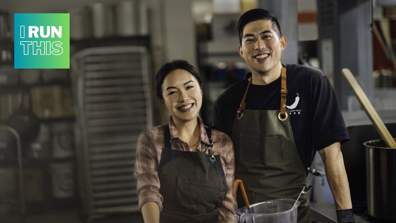Christopher Fung and Louise Pang smiling in a kitchen.