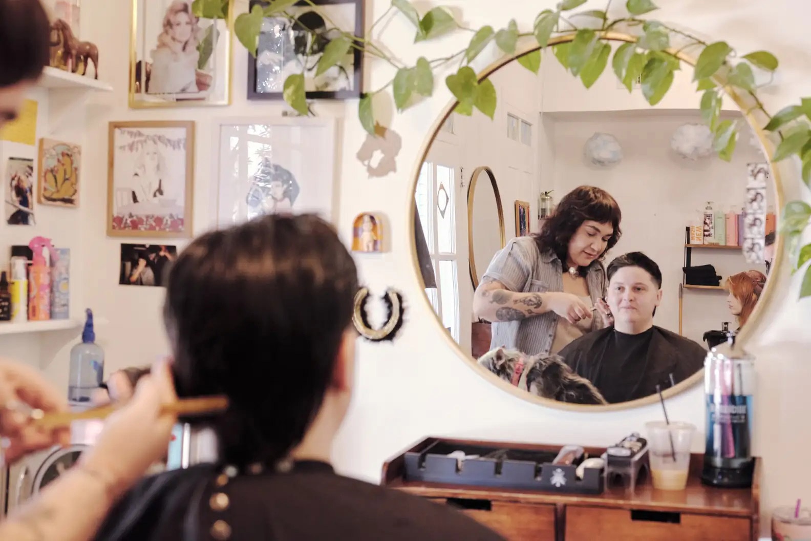 A person is getting a hair cut at a salon.