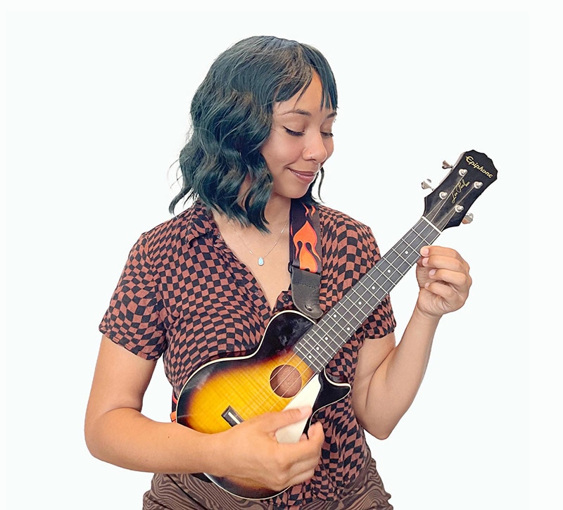 A person playing a guitar and a keyboard.