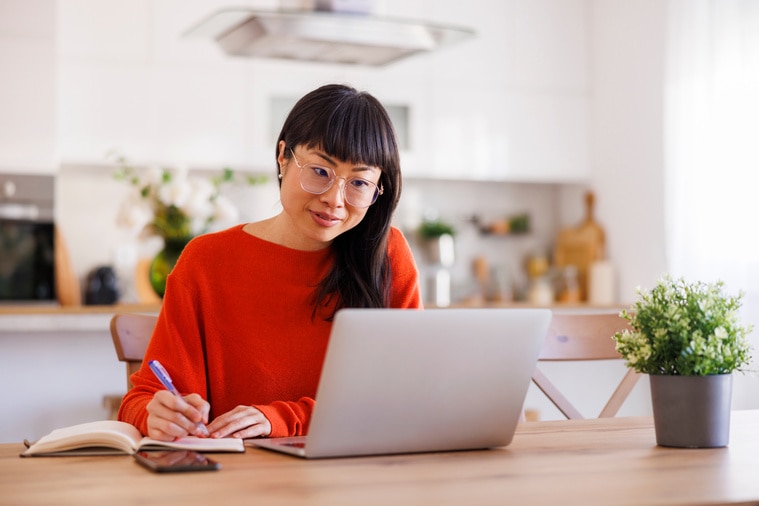Woman studying at home with laptop