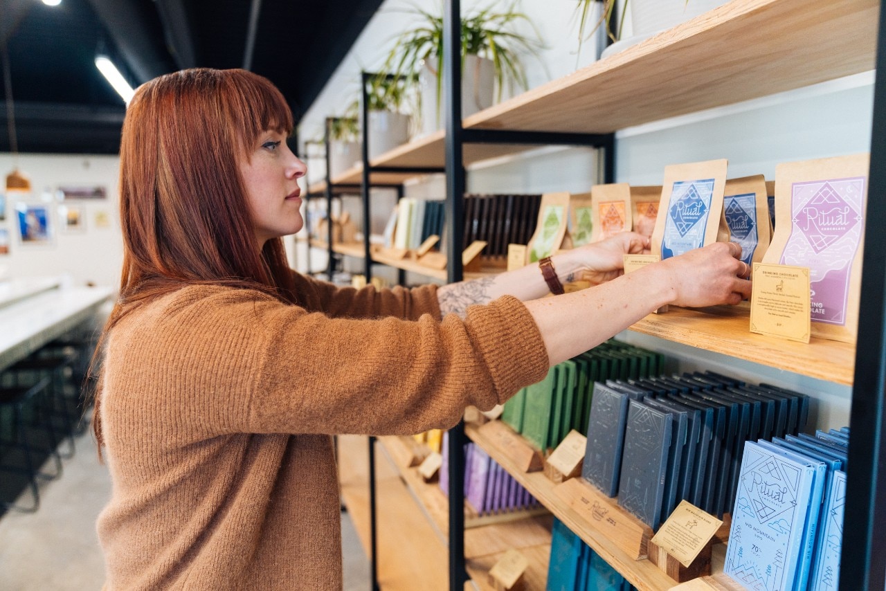 Business owner Anna Seear puts cacao on the shelf. 