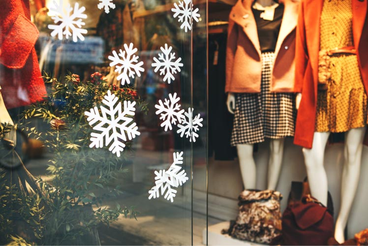 A photo of diy snowflakes in a holiday storefront window