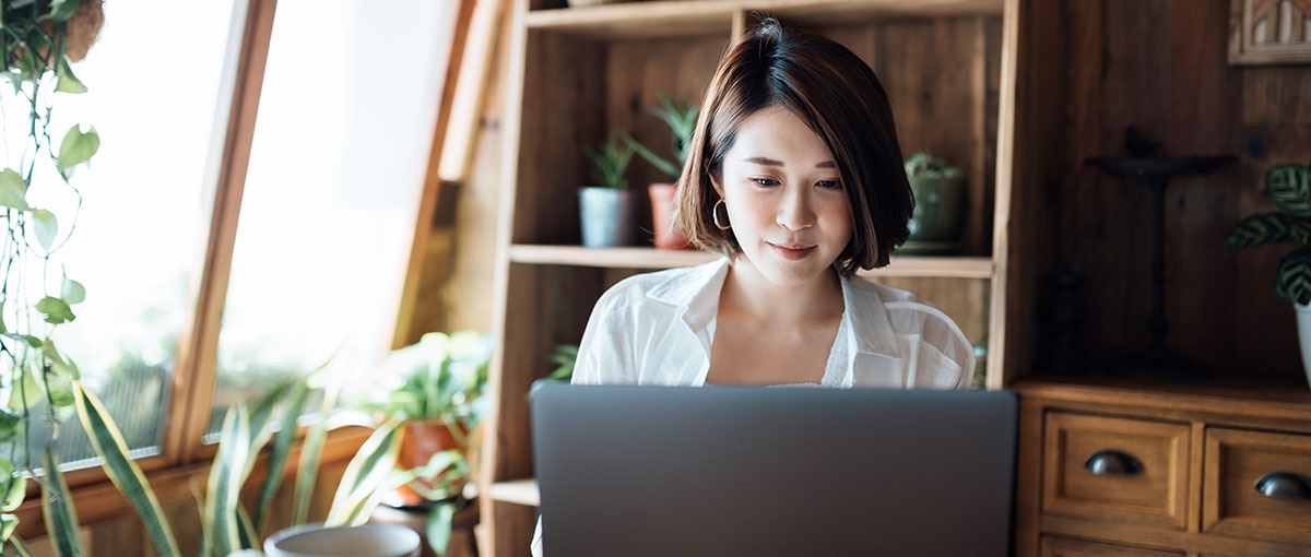 Image of a person carrying out double-entry bookkeeping on a desktop or laptop.