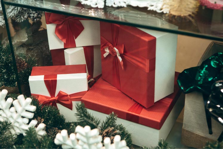 a photo of gift boxes sitting in a holiday storefront