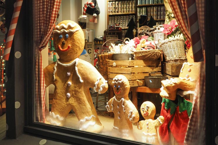 A holiday window storefront featuring gingerbread men