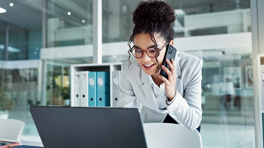 Businesswoman discussing Intuit Enterprise Suite over the phone.