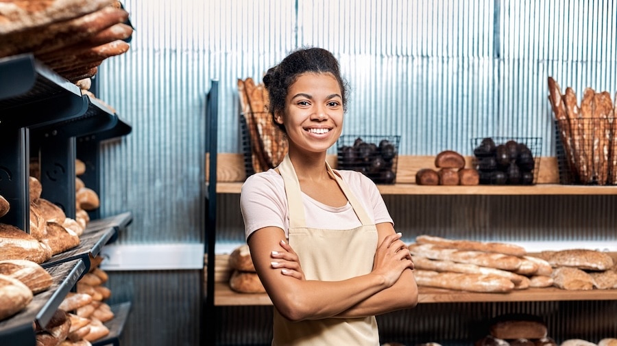 Business owner smiling in a bakery.