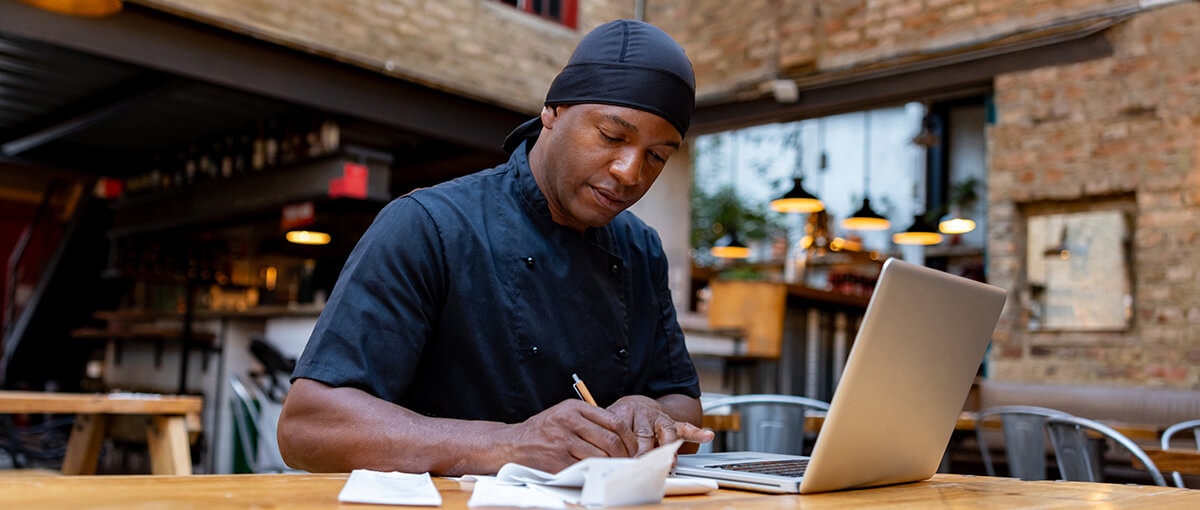 A manager going over the matching principle on a laptop.