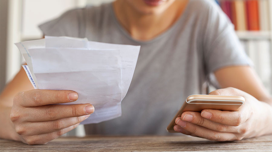 Woman hands with bills and mobile phone