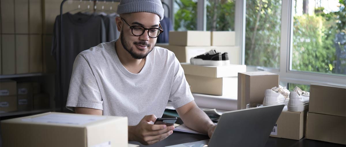 A freelancer filing taxes using their phone and computer