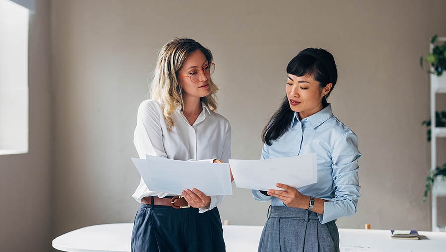Two executives discussing trade-off vs. opportunity cost.