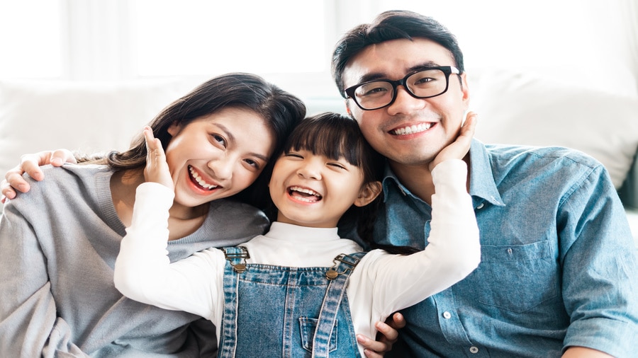 Smiling mother, father and daughter