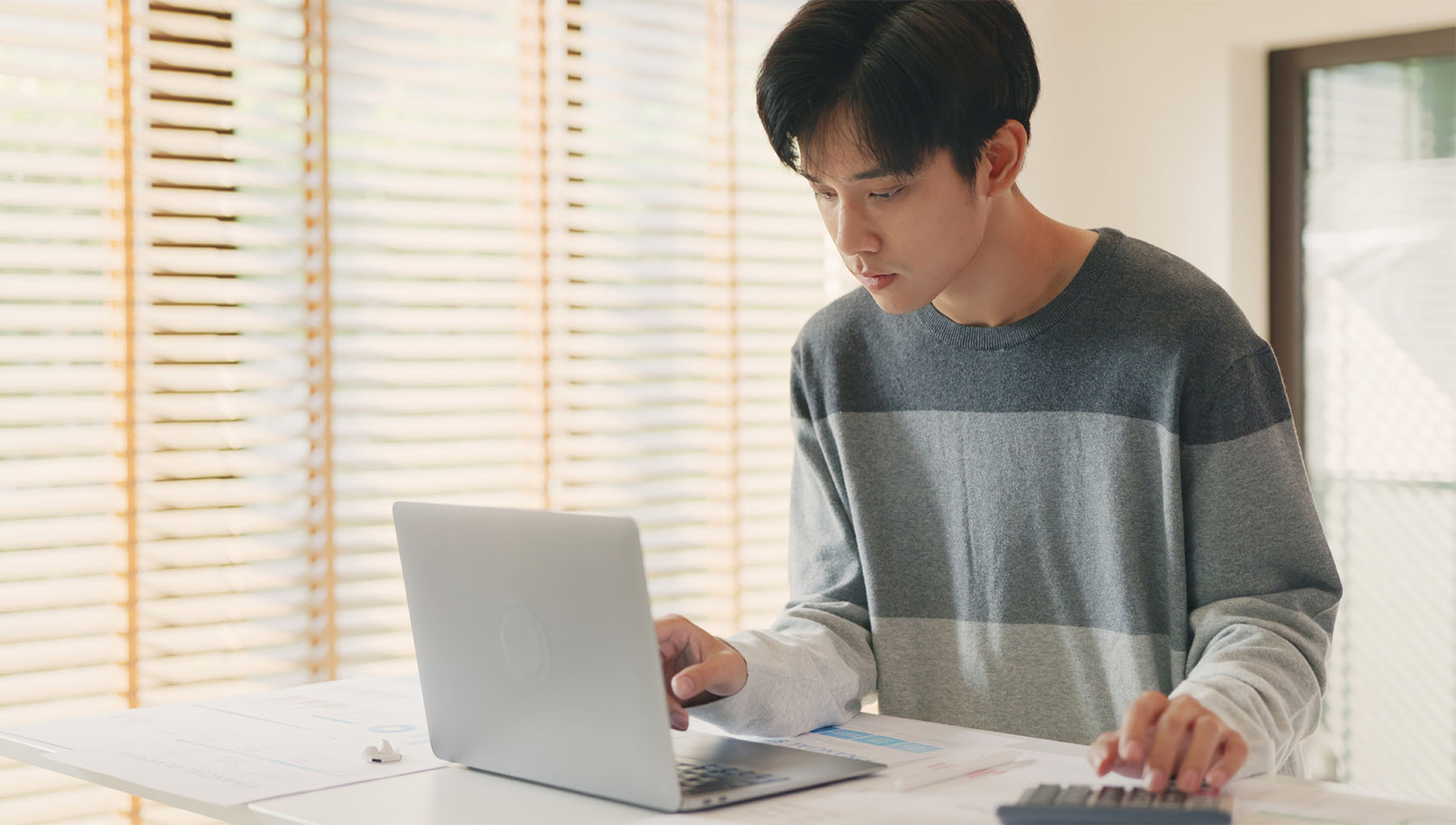 A business owner calculating gross profit on their computer.