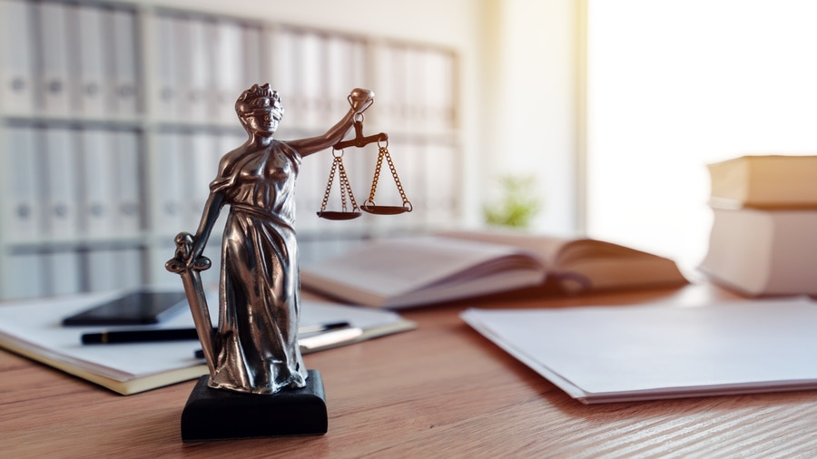 Lady Justice statue on a desk in a law office.