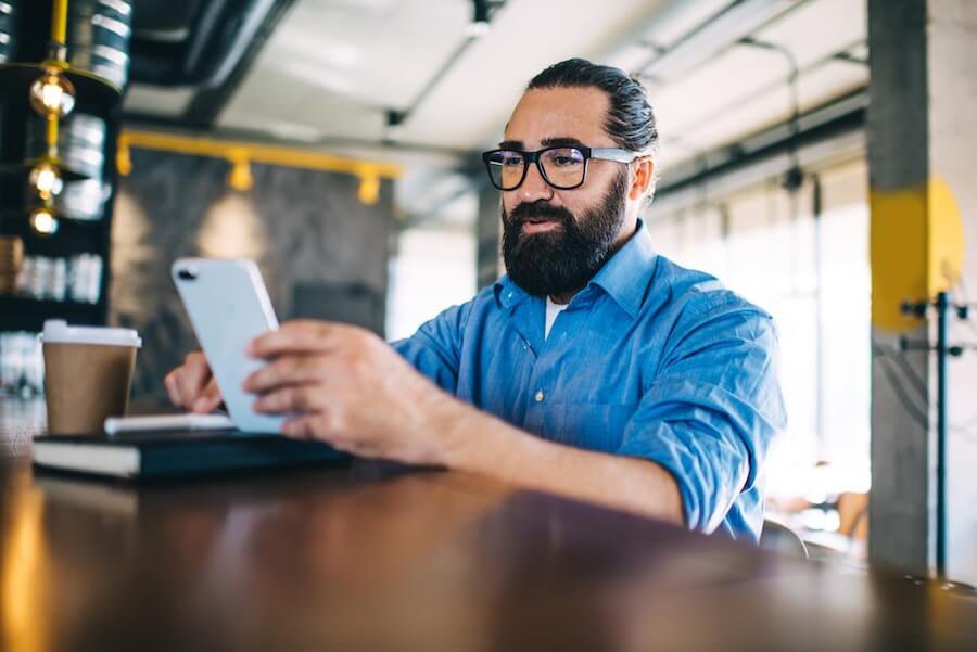 Business owner creating and sending invoices from his phone using QuickBooks Mobile.