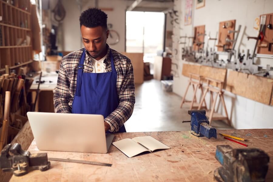 Business owner navigating QuickBooks Workforce on his laptop.