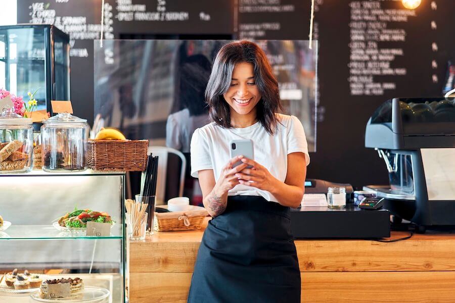 Small business owner managing the books on her phone.